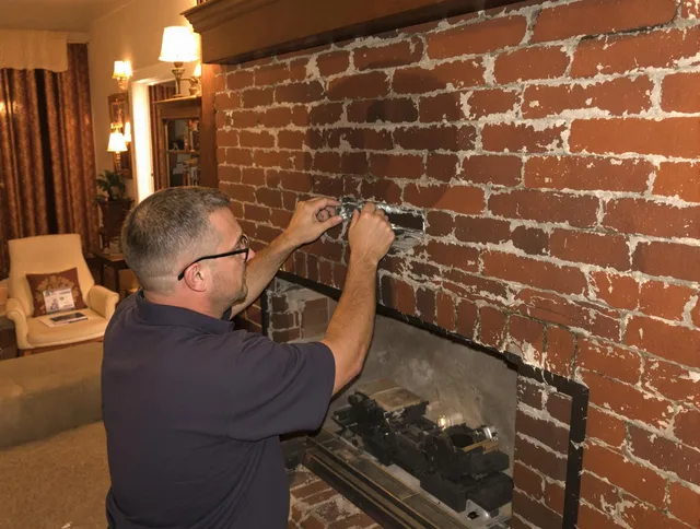 Broadview Heights Chimney Sweep expert fixing a fireplace in Broadview Heights, OH
